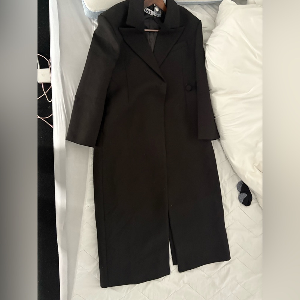 Because of Alex coat long and has one button on the side with split.